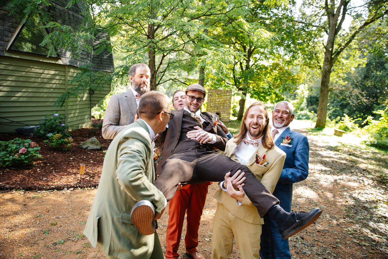 Wedding party laughing together outdoors