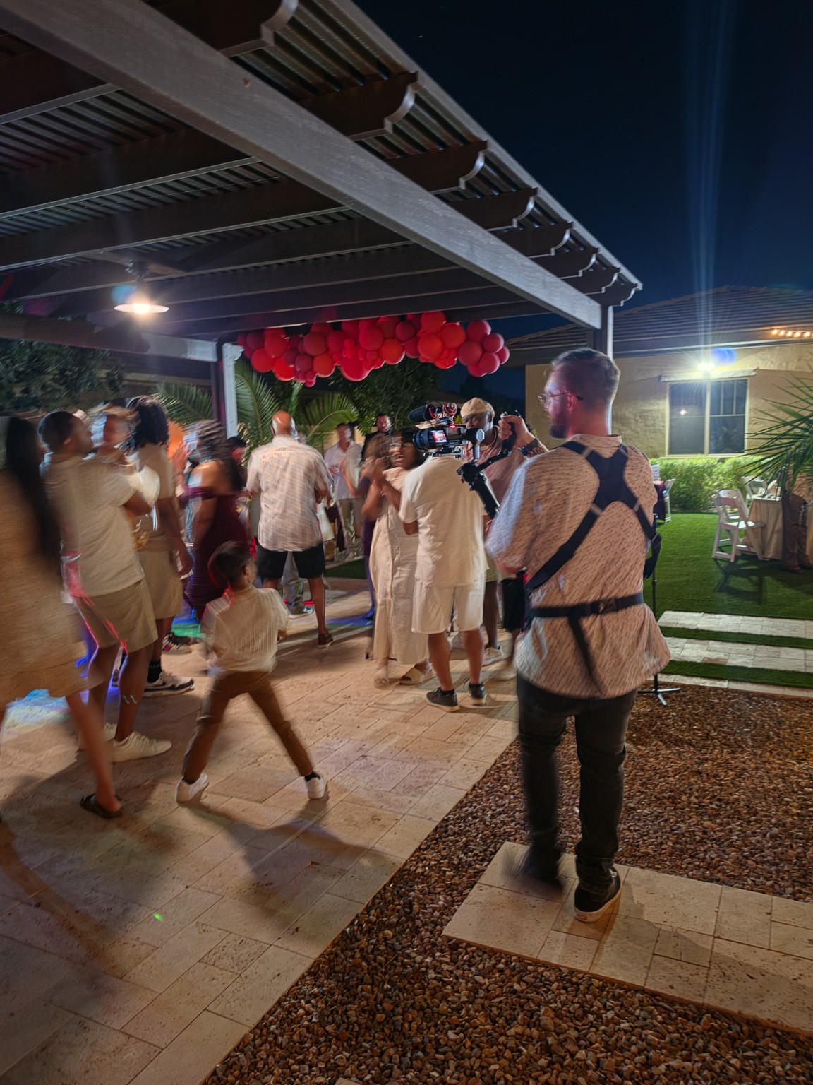 Steady Hands videographer filming guests on a wedding dance floor