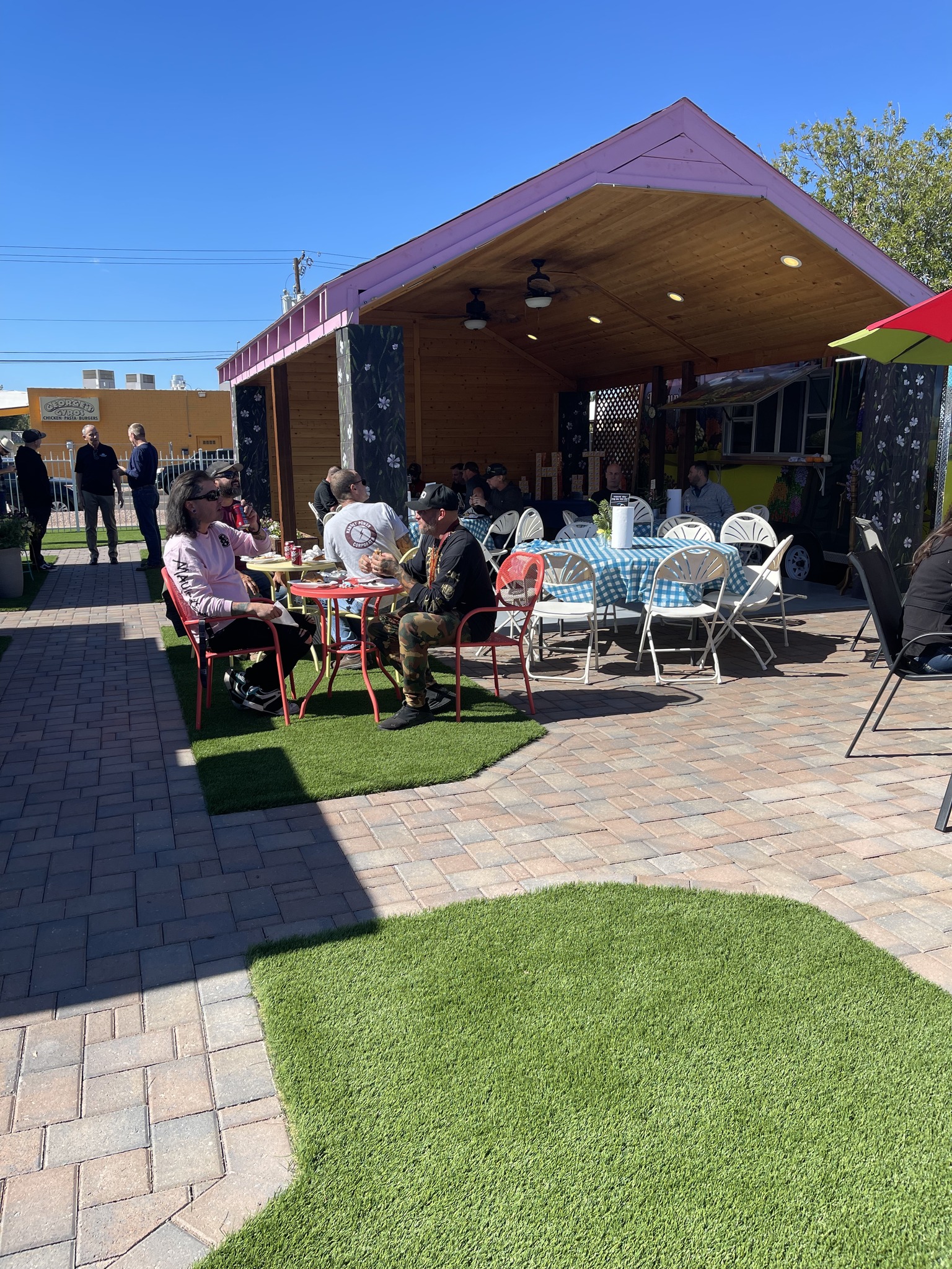 Guests seated beside the pavilion at a Mrs. Potts vendor gathering