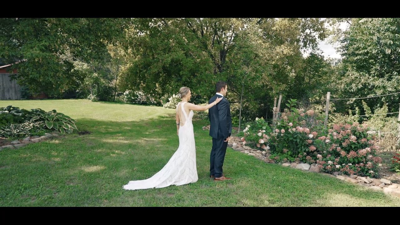 A couple seeing each other in a garden on their wedding day